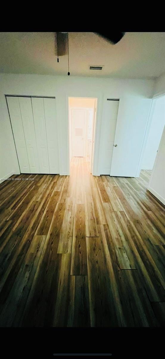 unfurnished bedroom with hardwood / wood-style floors and a closet