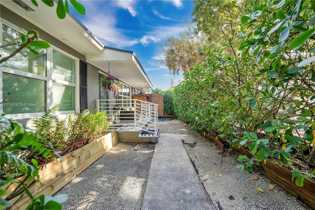 view of side of home featuring fence