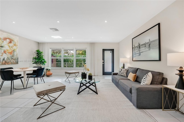 living room featuring light tile patterned flooring, visible vents, and recessed lighting