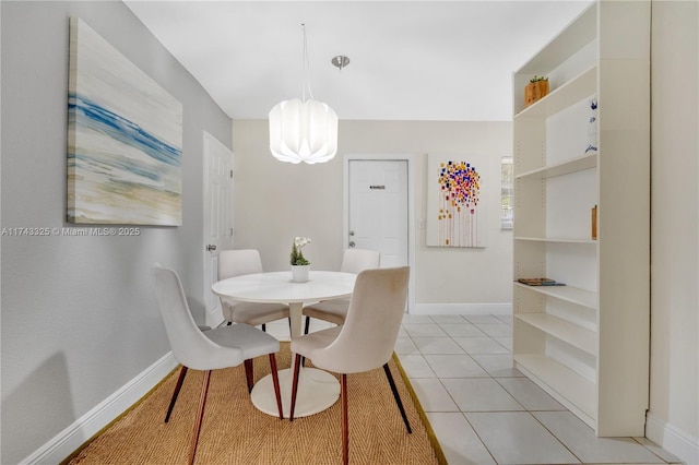 dining room featuring an inviting chandelier, baseboards, and light tile patterned floors