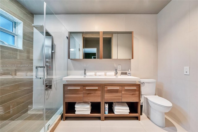 bathroom featuring a stall shower, tile patterned flooring, toilet, and double vanity