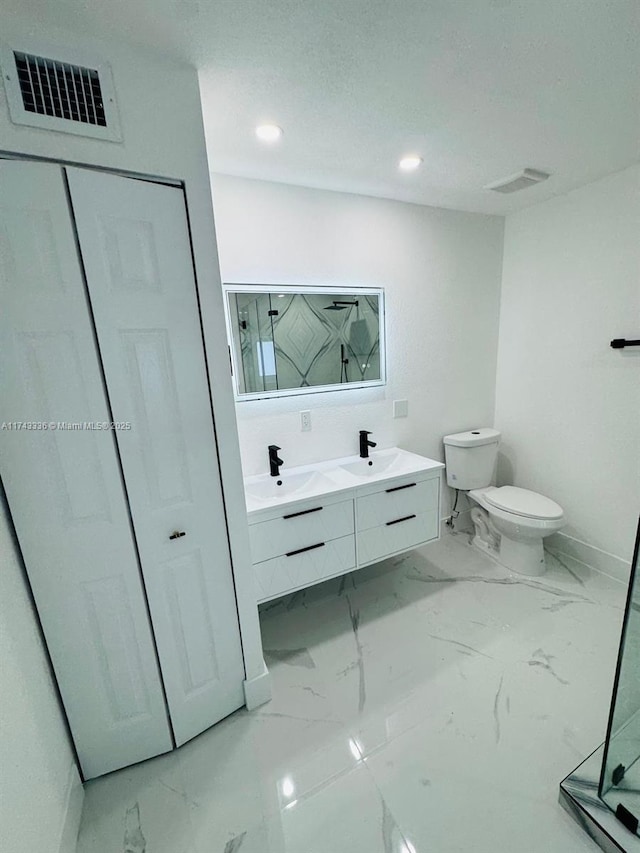 bathroom featuring vanity, a shower, and toilet