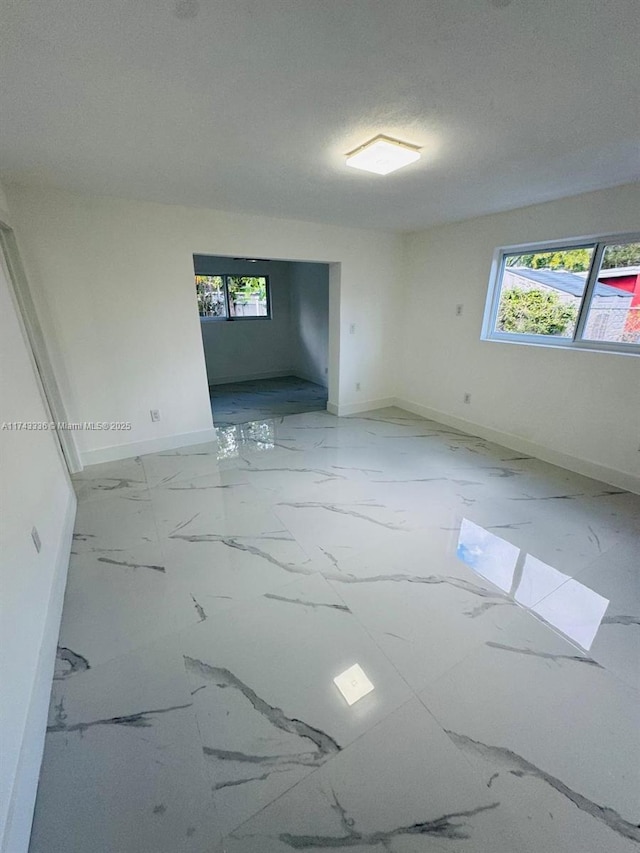 unfurnished room with plenty of natural light and a textured ceiling