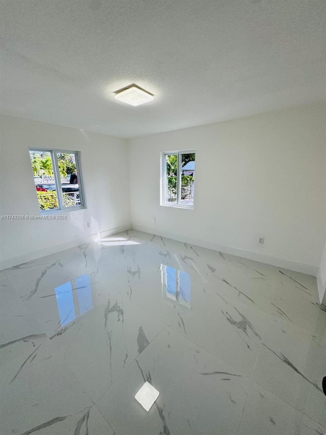 empty room featuring a textured ceiling