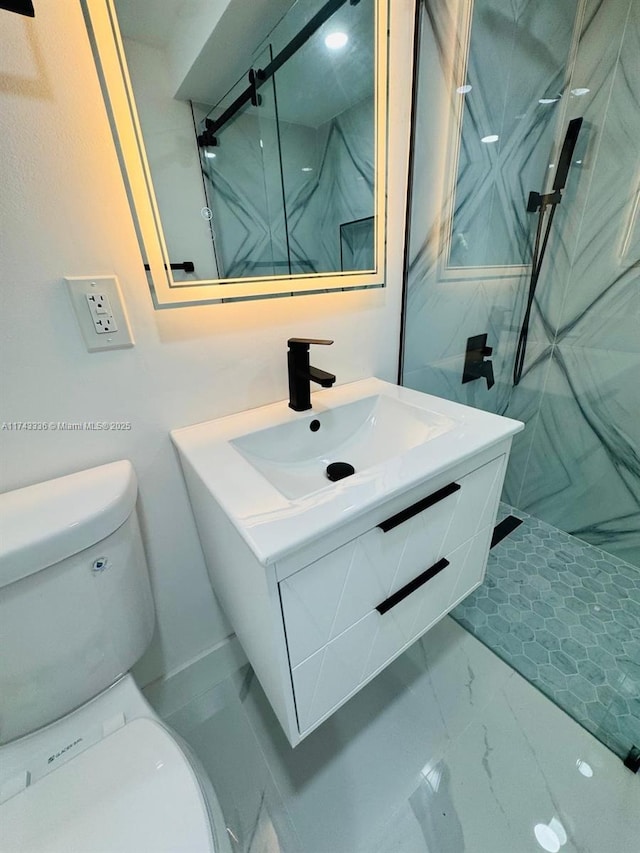 bathroom with vanity, toilet, and a tile shower