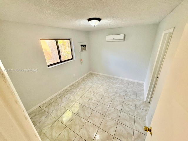 unfurnished room featuring a textured ceiling and a wall mounted AC