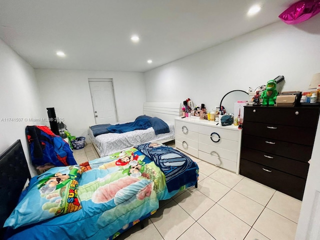 bedroom featuring light tile patterned floors and recessed lighting