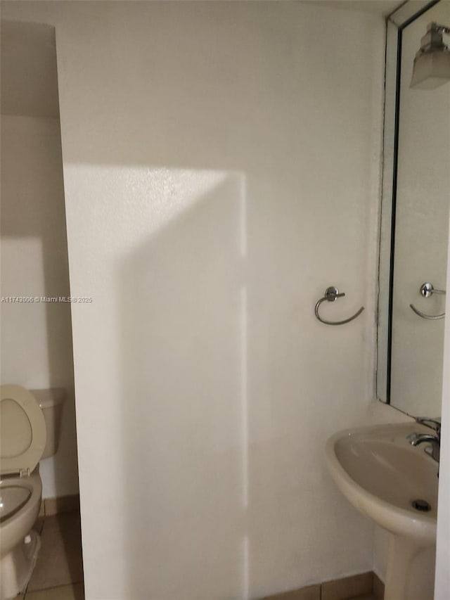 bathroom with tile patterned floors, toilet, and sink