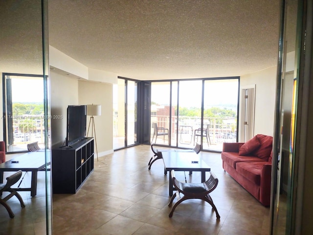 living room featuring floor to ceiling windows and a textured ceiling