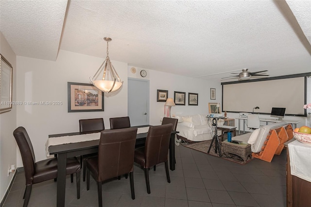 tiled dining room with ceiling fan and a textured ceiling