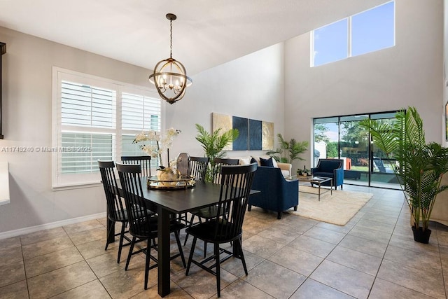 dining space featuring light tile patterned floors and an inviting chandelier