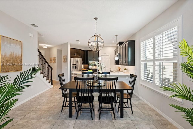 tiled dining space featuring a chandelier