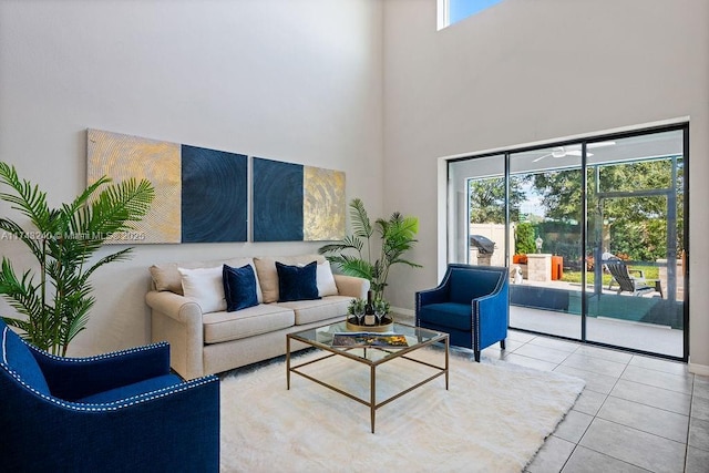 tiled living room featuring a towering ceiling