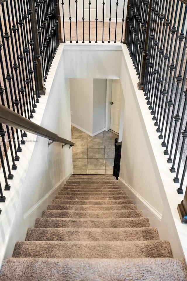 staircase with tile patterned floors