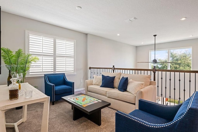 carpeted living room featuring a textured ceiling