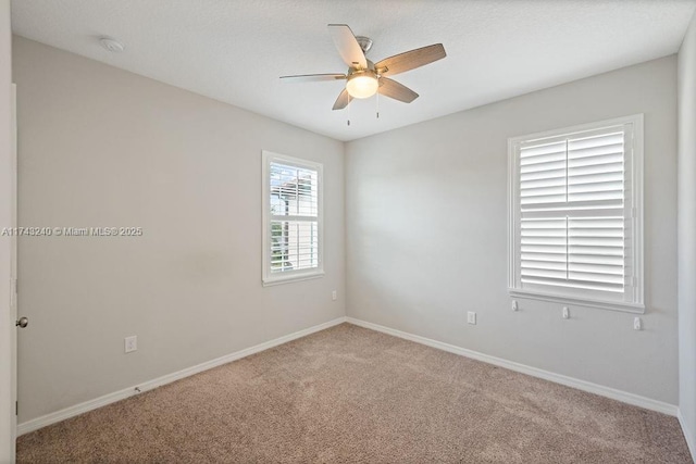 carpeted empty room featuring ceiling fan