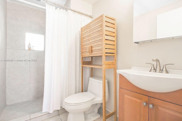 bathroom featuring tile patterned flooring, vanity, and toilet