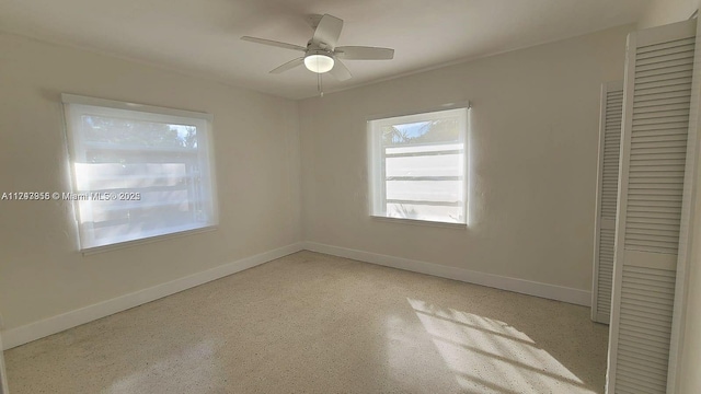 unfurnished bedroom with ceiling fan, baseboards, and a closet