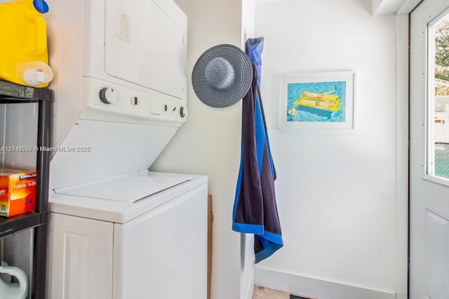 laundry area with stacked washer and dryer and laundry area