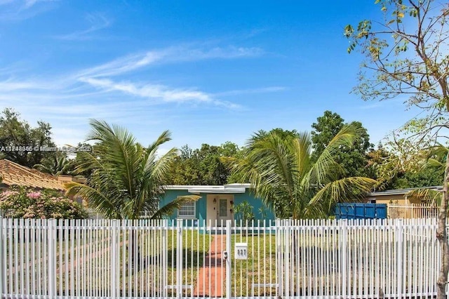 view of gate with a fenced front yard