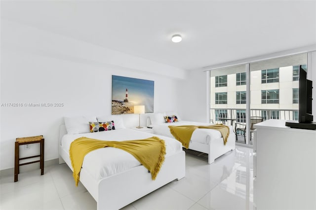 tiled bedroom featuring expansive windows and access to exterior