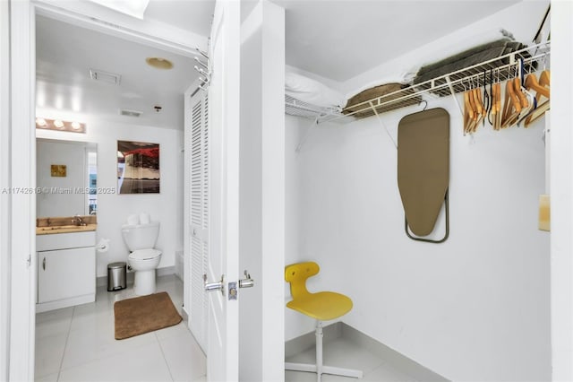 bathroom featuring tile patterned floors, vanity, and toilet