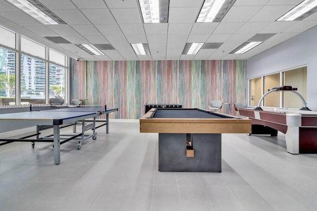 playroom with a paneled ceiling, light tile patterned floors, and billiards