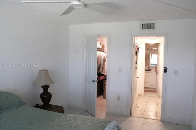 bedroom featuring ensuite bath and ceiling fan