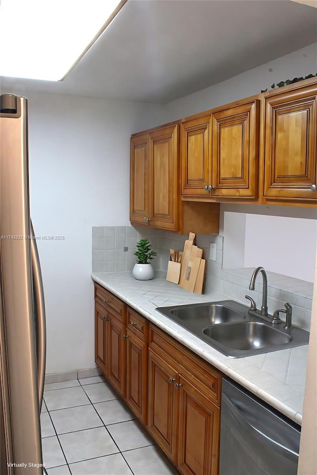9455 W Flagler St Unit C409, Miami, FL 33174 - kitchen featuring stainless steel appliances, light countertops, brown cabinets, and tasteful backsplash