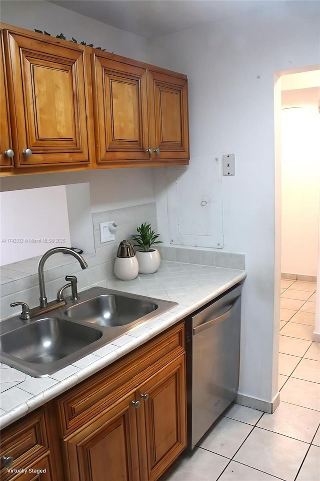 9455 W Flagler St Unit C409, Miami, FL 33174 - kitchen with dishwasher, brown cabinets, light tile patterned flooring, and light countertops