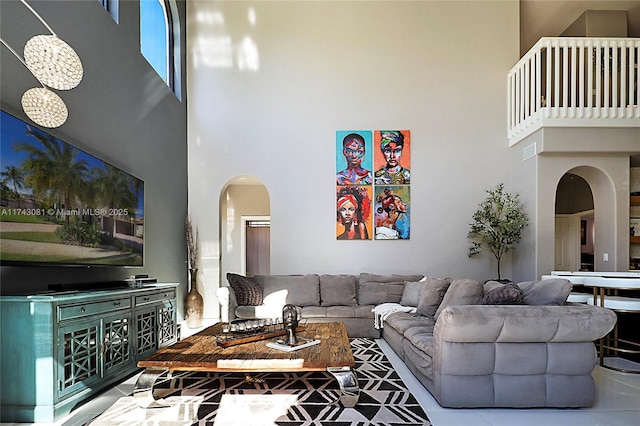 living room featuring a towering ceiling