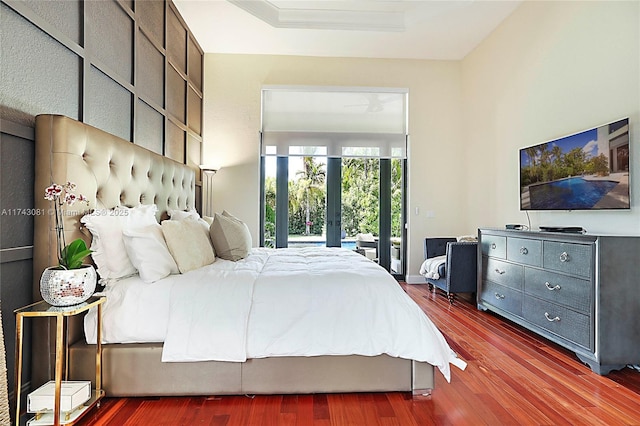 bedroom featuring french doors, dark hardwood / wood-style flooring, and access to outside