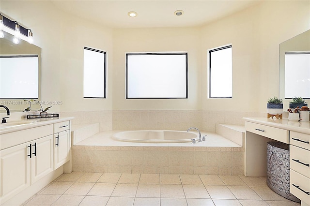 bathroom featuring tile patterned floors, vanity, and tiled tub