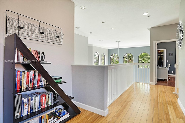 hall with hardwood / wood-style floors