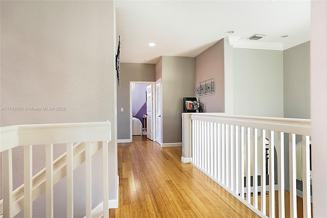 hallway with hardwood / wood-style floors