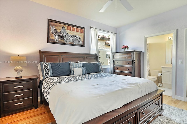 bedroom with ensuite bathroom, ceiling fan, and light hardwood / wood-style flooring