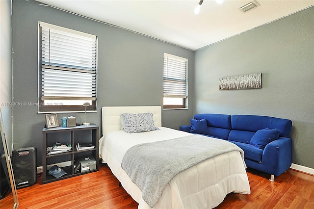 bedroom with hardwood / wood-style floors