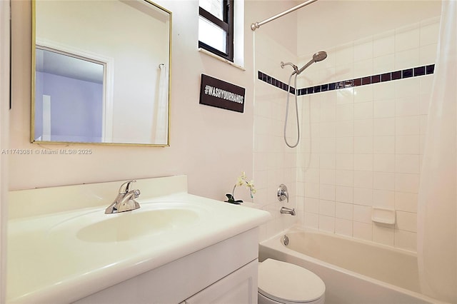 full bathroom featuring vanity, toilet, and tiled shower / bath combo