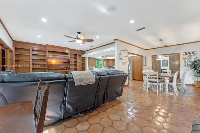 living room with crown molding, ceiling fan, and built in shelves