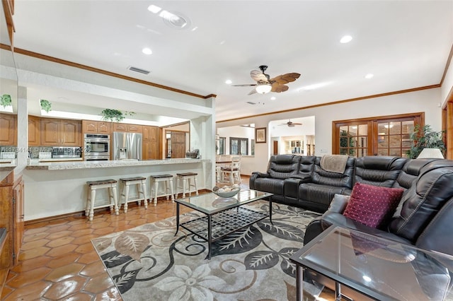 tiled living room featuring crown molding and french doors