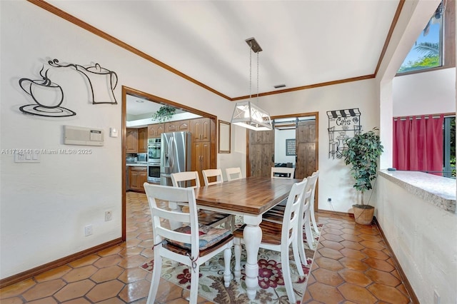 dining room featuring crown molding, plenty of natural light, and a barn door