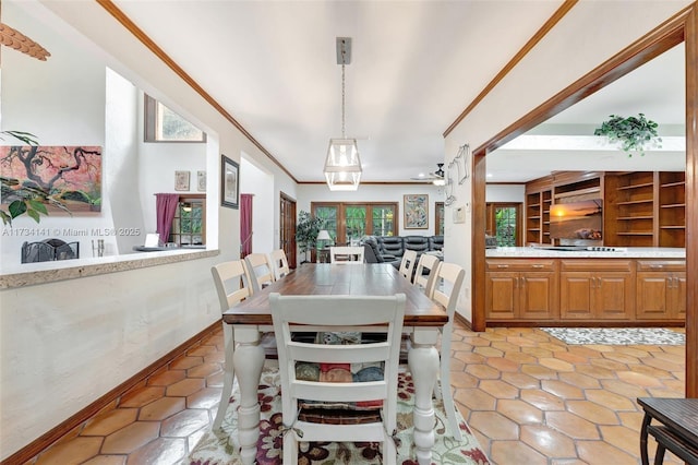 dining area featuring crown molding and ceiling fan