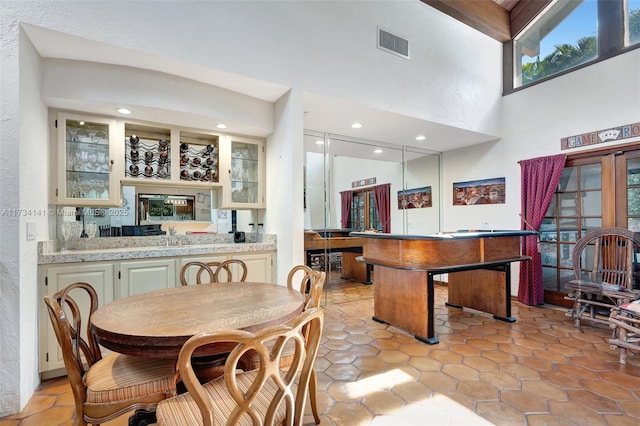 dining area featuring a towering ceiling