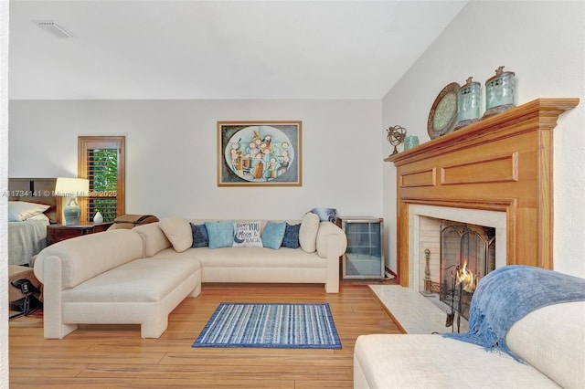 living room with hardwood / wood-style floors and a fireplace