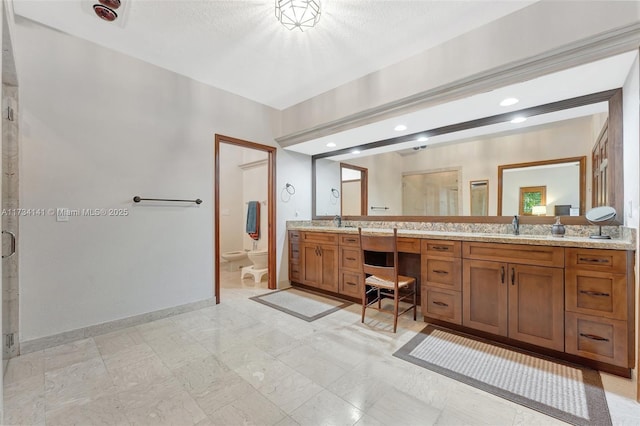 bathroom featuring a shower with door, a bidet, vanity, and toilet