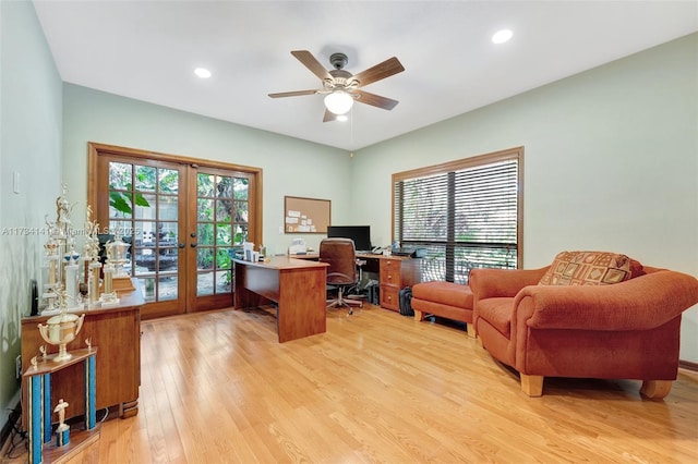 office space with plenty of natural light, french doors, ceiling fan, and light wood-type flooring