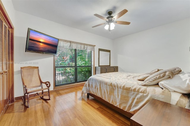 bedroom featuring ceiling fan, a closet, and light wood-type flooring