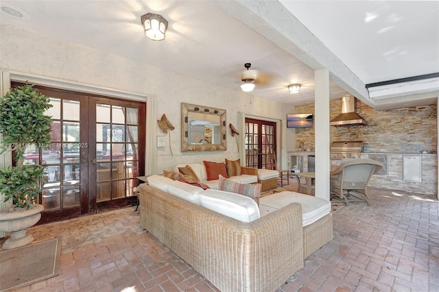 living room featuring french doors and beamed ceiling