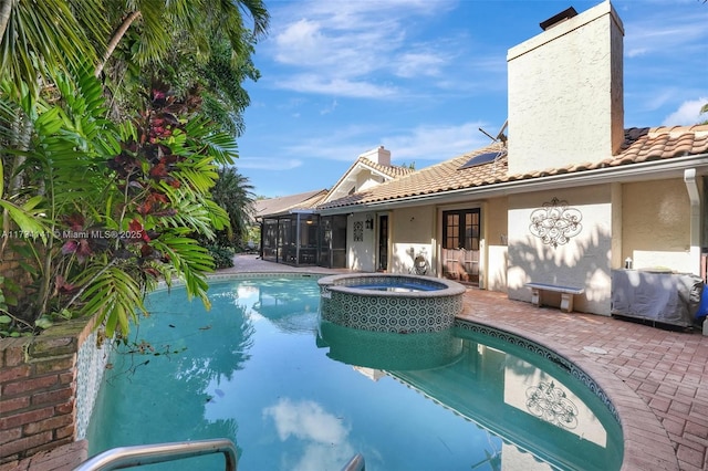 view of pool featuring an in ground hot tub and a patio