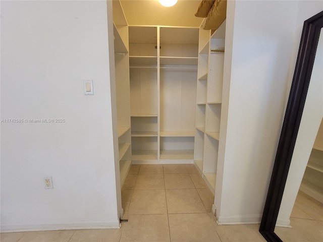 walk in closet with light tile patterned flooring